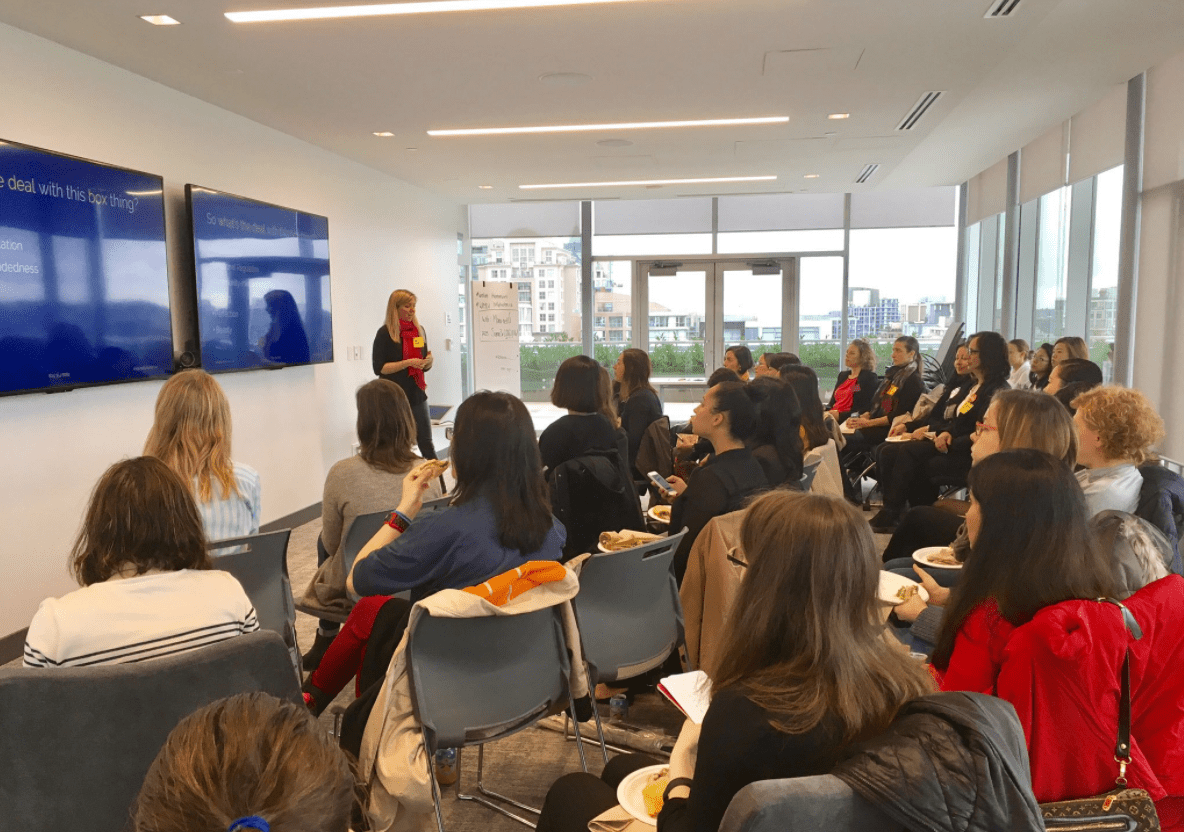 Holly Burton, Leadership Coach for Women in Male-Dominated Industries, speaks to a crowd of women in tech at Women in Tech Week 2017. Photo courtesy of Women in Tech World.