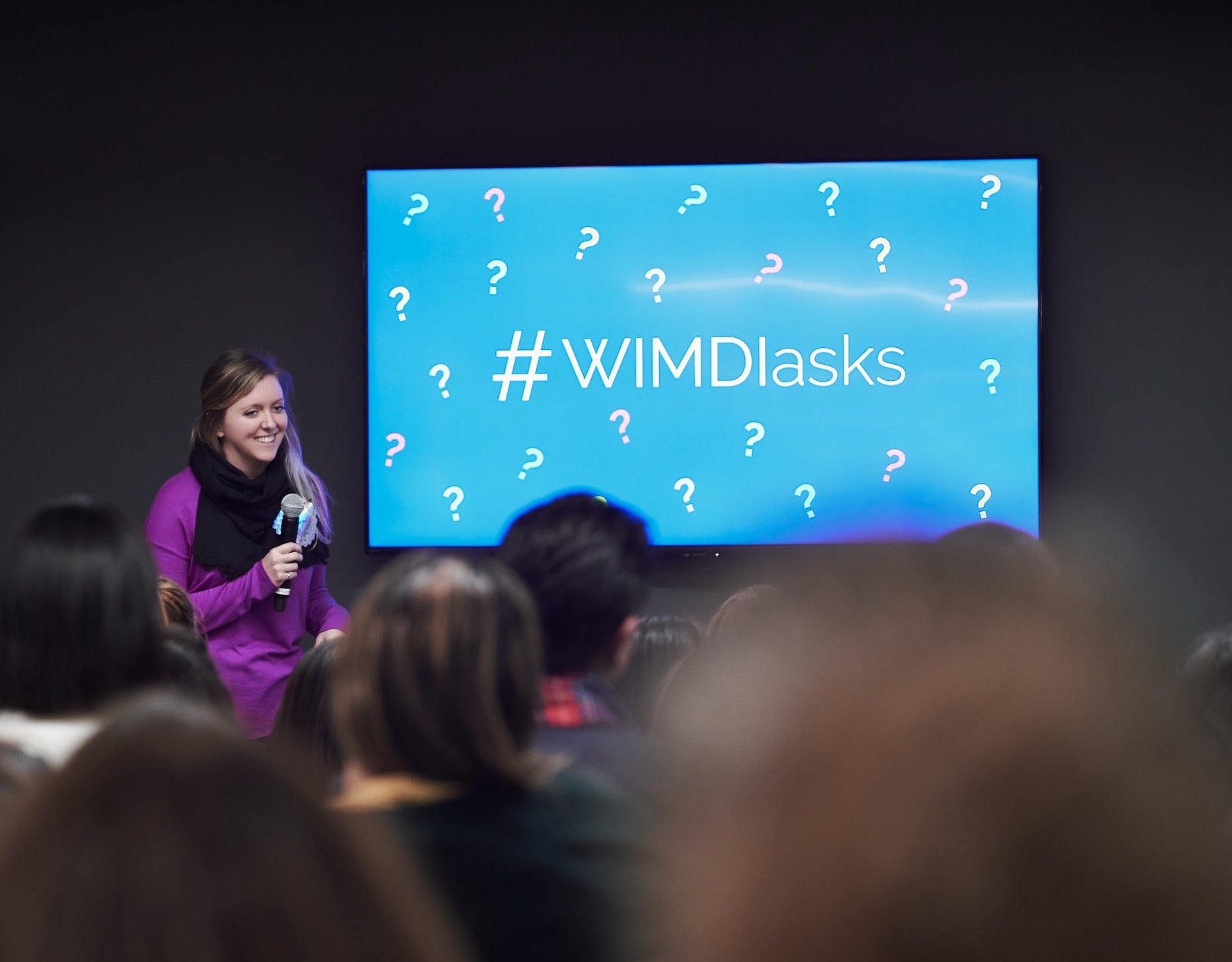 Holly smiles in front of audience speaking about the pillars of success for women in male-dominated industries | by Vancouver photographer Angela McConnell