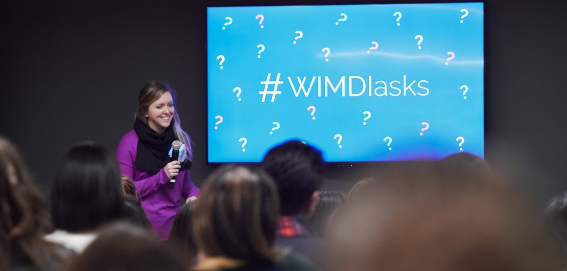 Holly smiles in front of audience speaking about the pillars of success for women in male-dominated industries