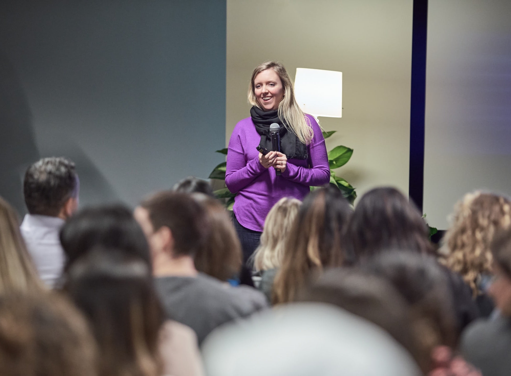 Holly stands in front of audience as part of her talk on the inescapable competency trap women face at work | by Vancouver photographer Angela McConnell