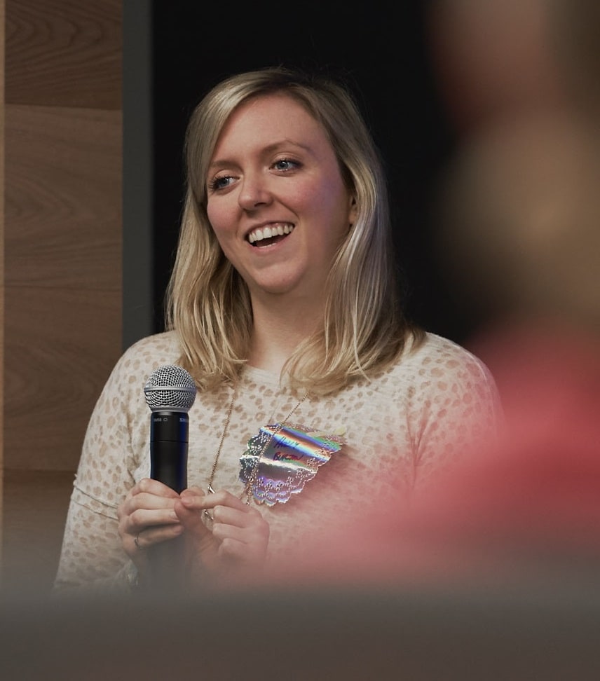 Holly smiles to group during talk on how women undercut their brilliance at work | by Vancouver photographer Angela McConnell